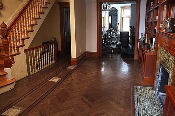 damaged hardwood floor area before spot sanding and repair in Forest Hills Queens