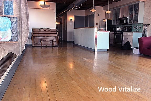 Worn maple hardwood floors before sanding and refinishing in Whitestone Queens NY apartment