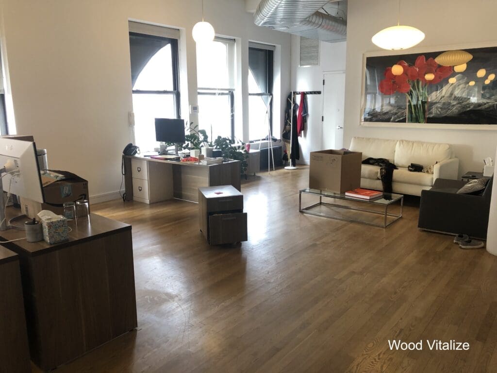 Commercial office hardwood floor cleaning with furniture in place in Tribeca NYC