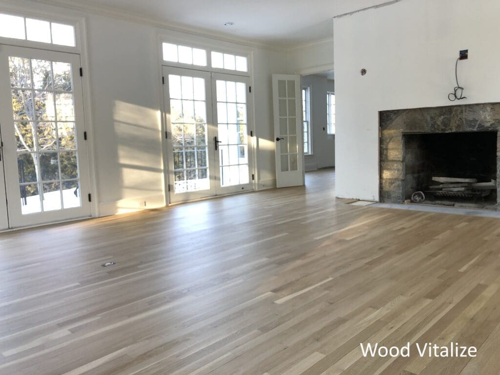 Refinished hardwood floors in living room with fireplace Douglaston Queens NY