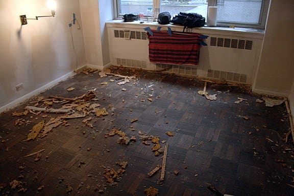 Before carpet removal in Cobble Hill Brooklyn with carpet debris left on parquet hardwood floor