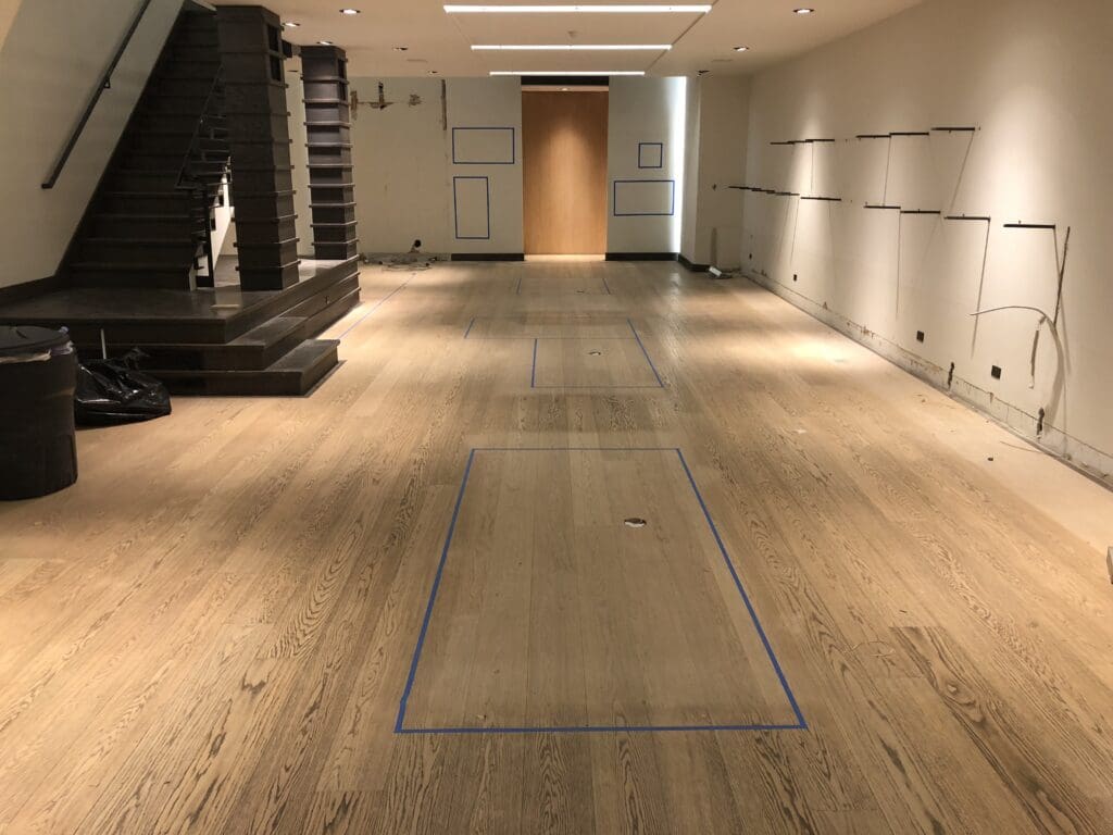 Before retail hardwood floor refinishing on 5th Ave
